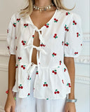 Blusa con estampado de cerezas y lazos en frente