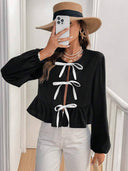 Blusa manga larga con lazos en el frente