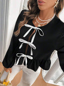 Blusa manga larga con lazos en el frente