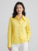 Camisa unicolor manga larga con botones dorados